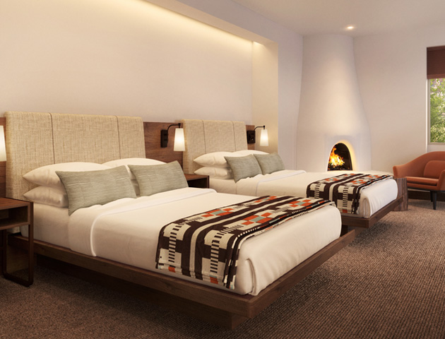 Casita Double Queen guestroom at Mii amo, a destination spa, Room with two beds, orange chair, lamp and fireplace