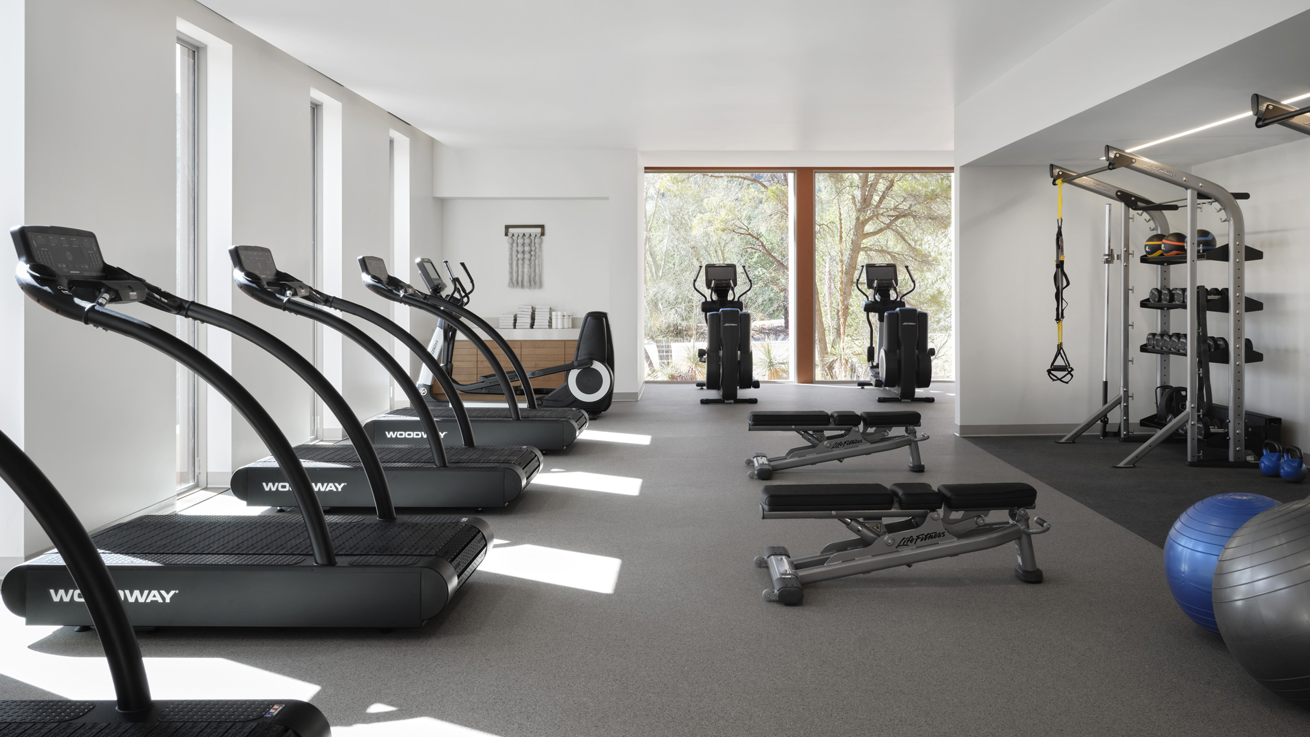 fitness center with treadmills and weights