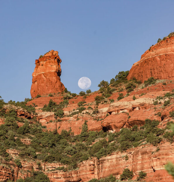 moon rising over the Boynton Canyon red rock walls surroundning Mii amo