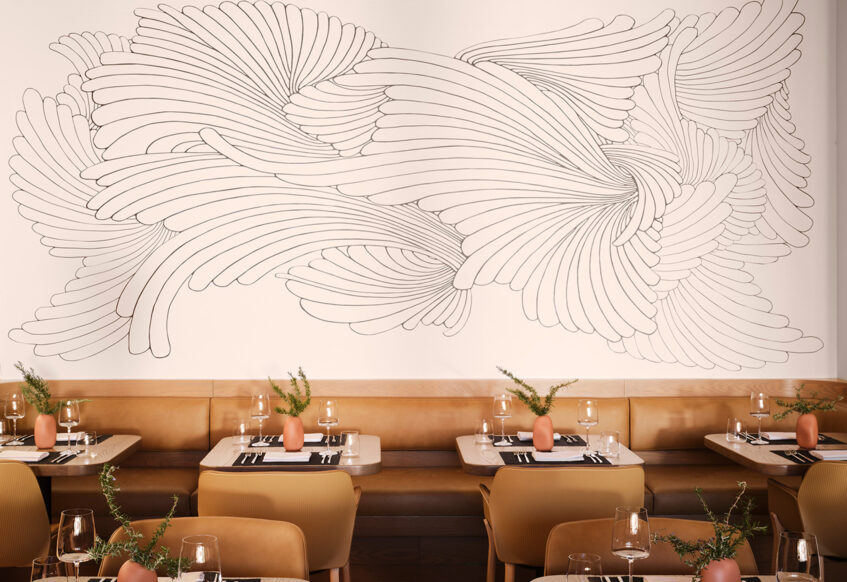 seating area in restaurant with wall mural