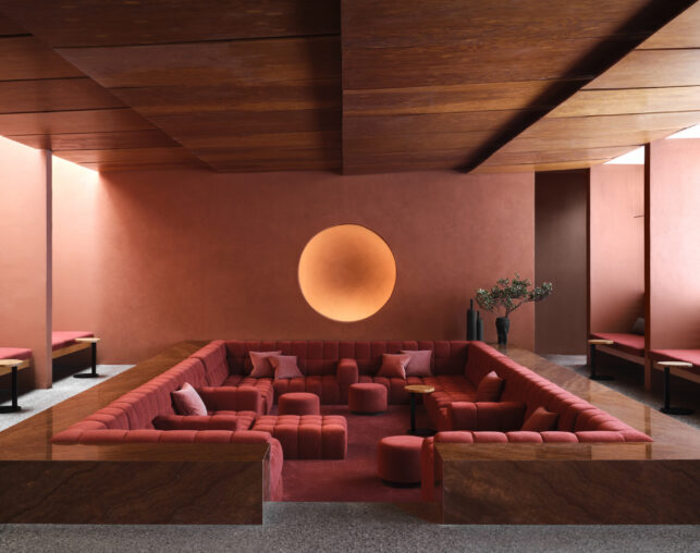 Sunken living room with red couches
